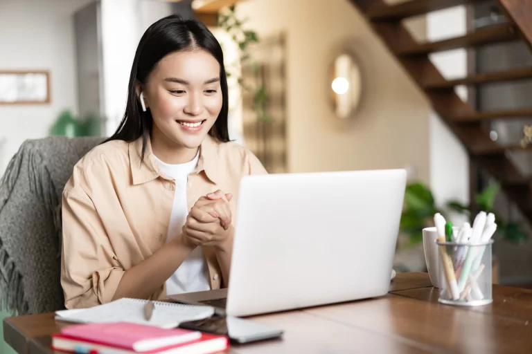 hiring-overseas-freelancers-asian-girl-work-from-home-using-laptop-for-presentation