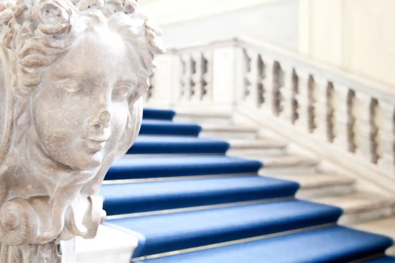 an image of a marble staircase with blue carpeting to symbolize achieving business goals using the right Australian AML Compliance program