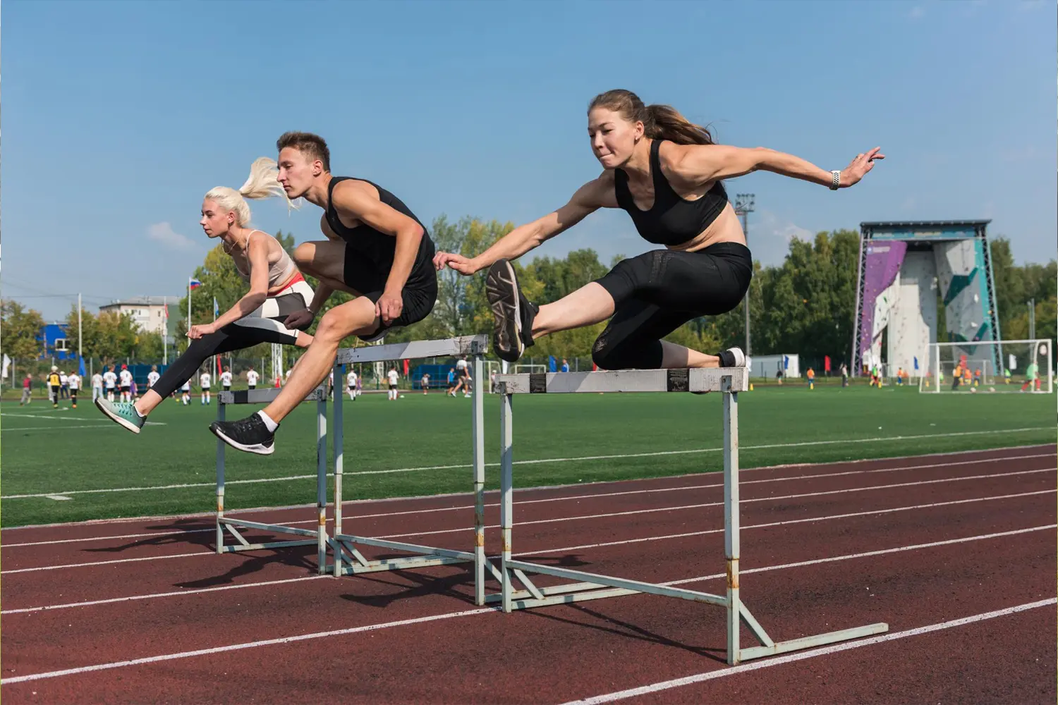 an image of two female and one male athlete doing hurdles, symbolizing the potential risks of compliance failure and having AML/CTF Penalties in Australia