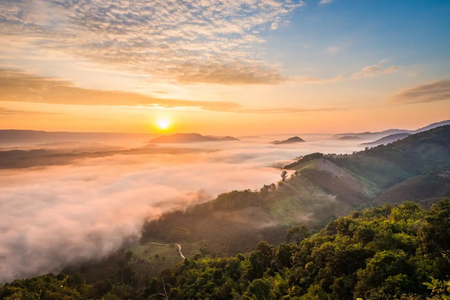an image of a mountain side covered in clouds during sunrise, symbolising the benefits if DBA Advisory's AML/CTF Compliance Program for Australian businesses