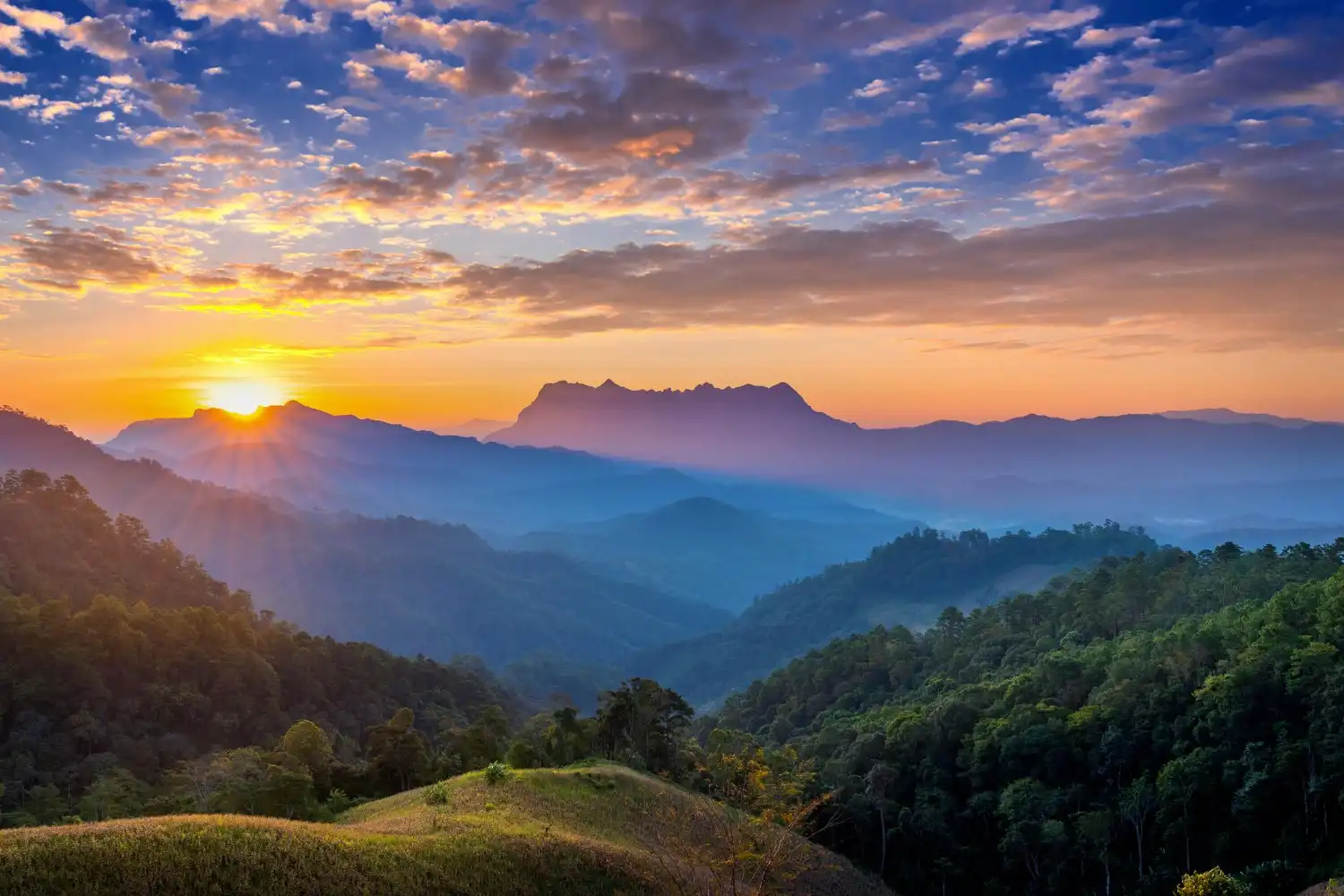 an image of a mountain top covered in fog and mist during sunrise, symbolising the significant benefits of achieving compliance and avoiding AML/CTF Penalties with DBA Advisory