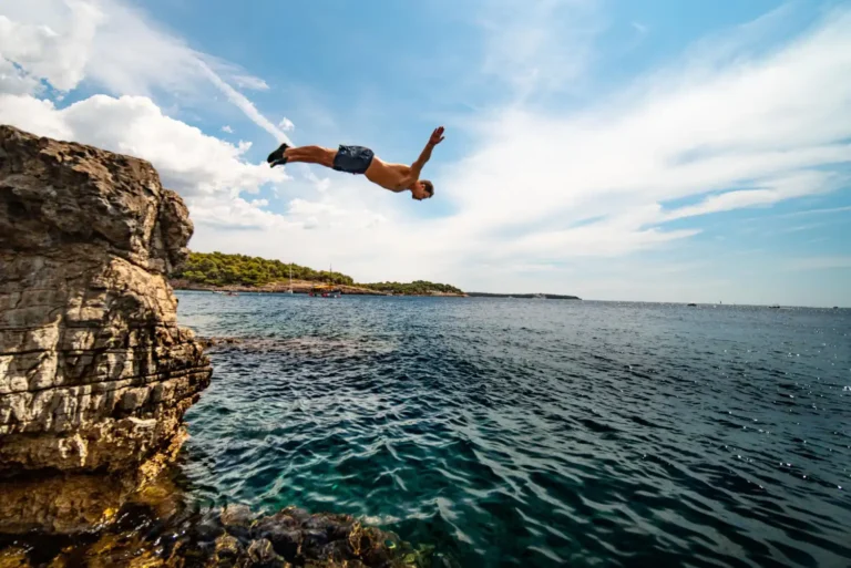 an image of a cliff diver mid-air, symbolising the confidence and peace of mind firms enjoy with DBA Advisory's AML/CTF Risk Assessment service