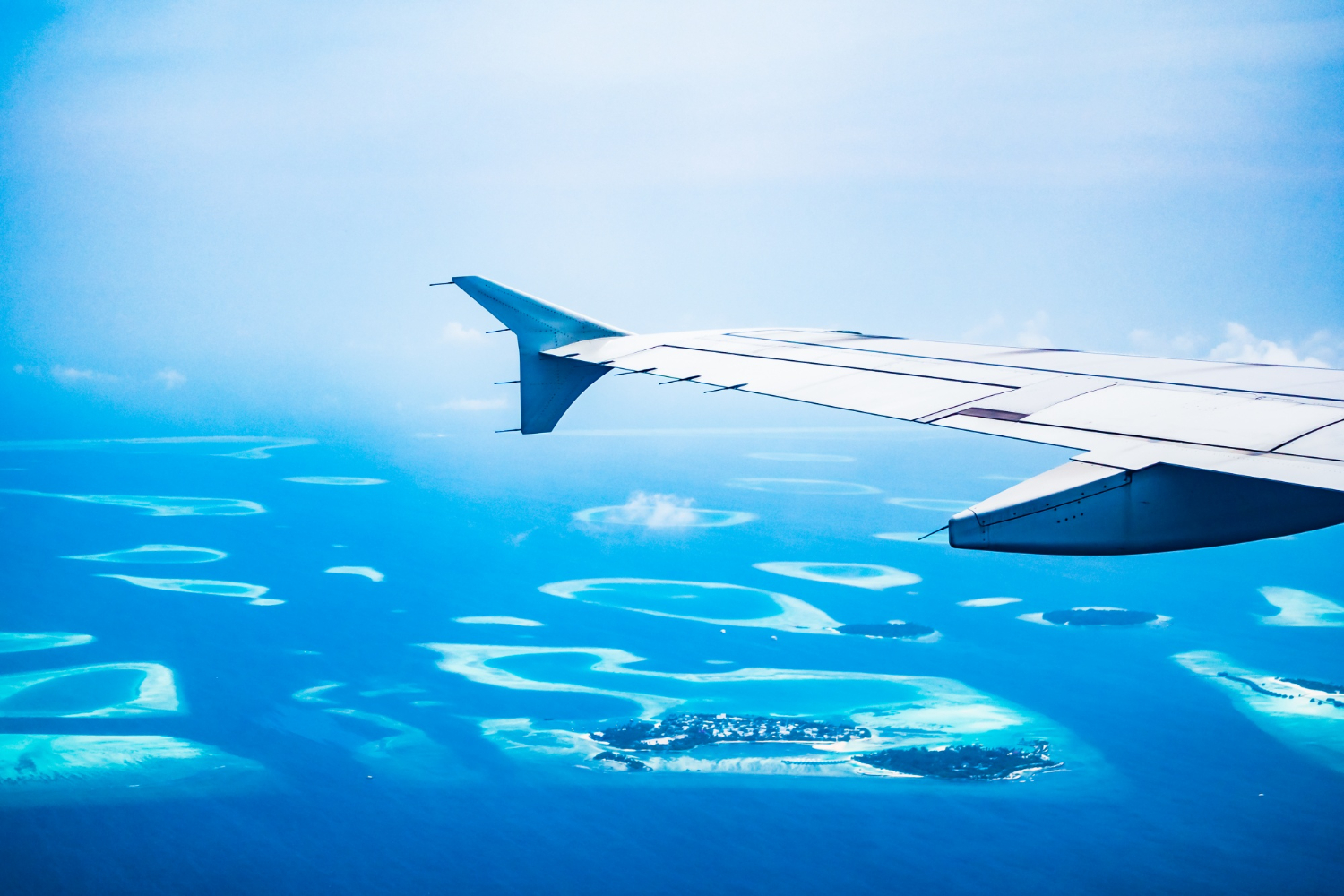 an image of a gorgeous group of tiny islands seen through an airplane window by the left wing, symbolising a stronger teamwork and network with DBA Advisory's AML/CTF Training Requirements Australia