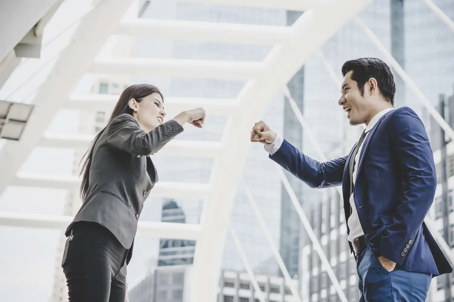an image of a male and female business professionals doing a fist bump, symbolising the wonderful partnership we have with our clients because of our reliable business advisory and outsourcing services