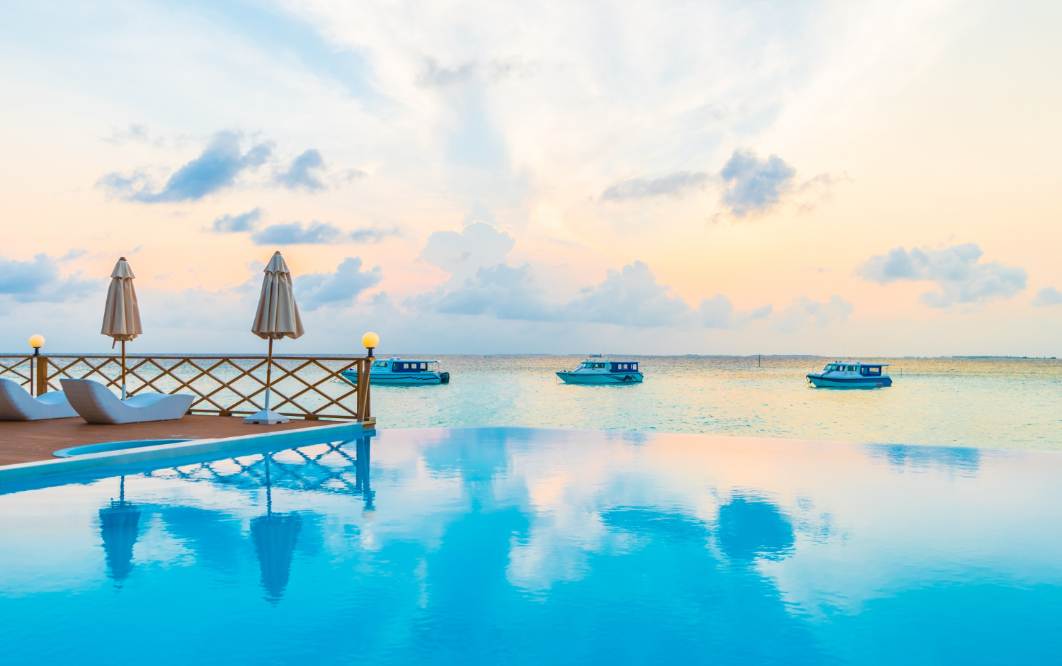 in image of a lovely resort with an infinity pool overlooking the beach, symbolising the peace of mind our Payday Super SMSF team gives their clients