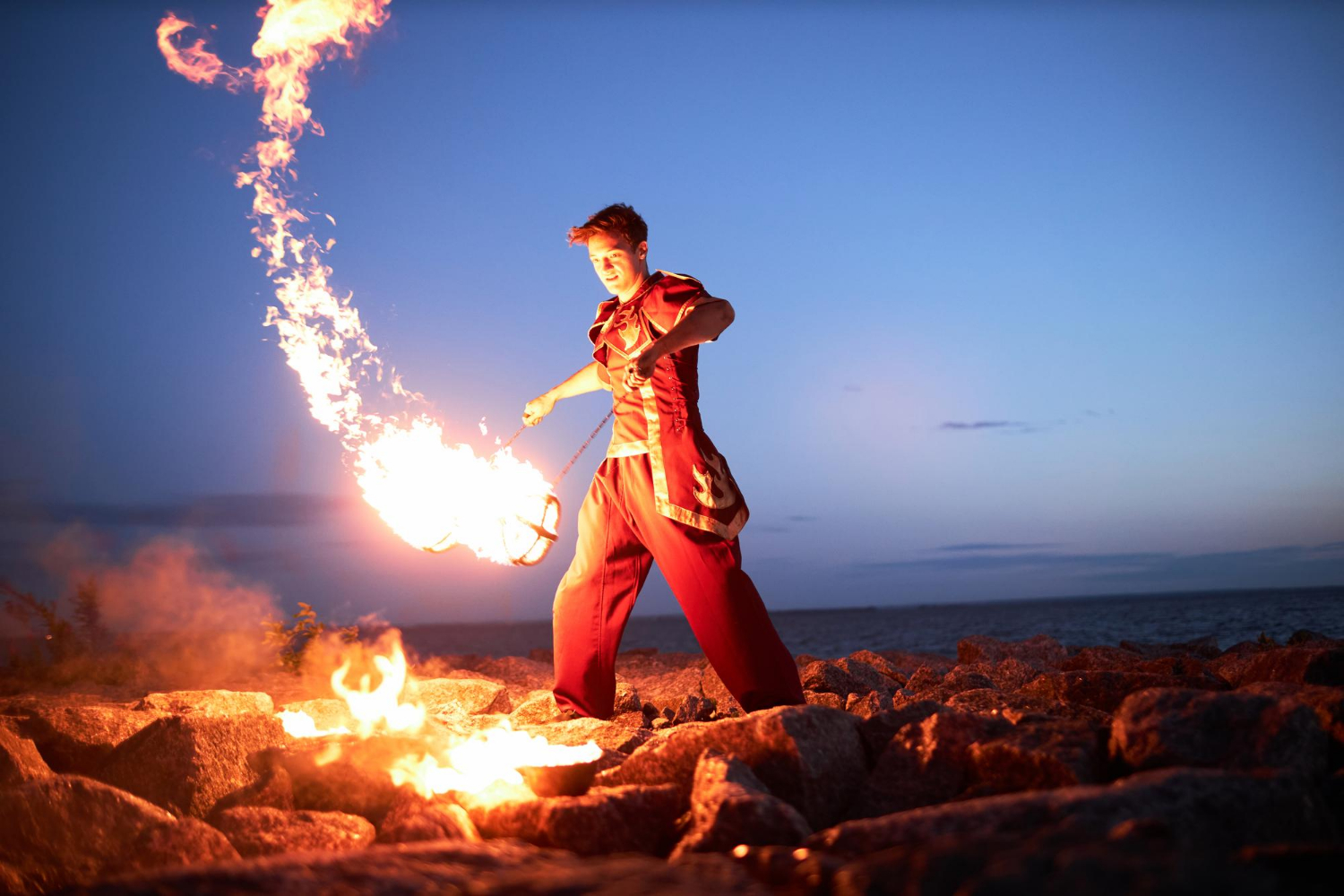 an image of a male fire dancer or performer, symbolising the