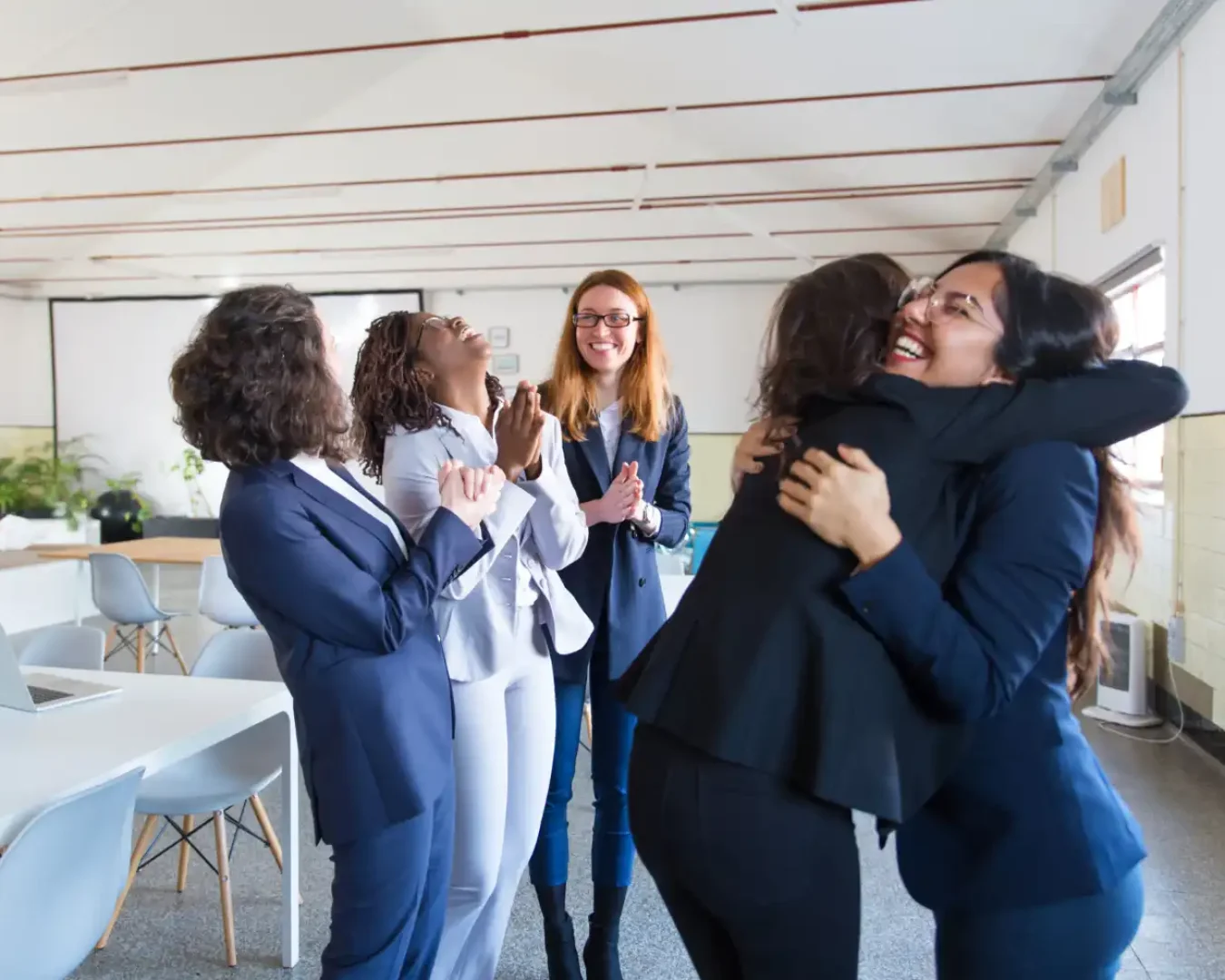an image of a team of women business specialists, celebrating the success of their client, symbolising the relationship we create