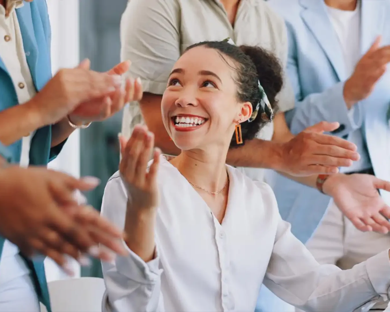 an image of a team of outsourced specialist celebrating the success of a team member, demonstrating DBA Advisory's Business Process Outsourcing with Senior Oversight