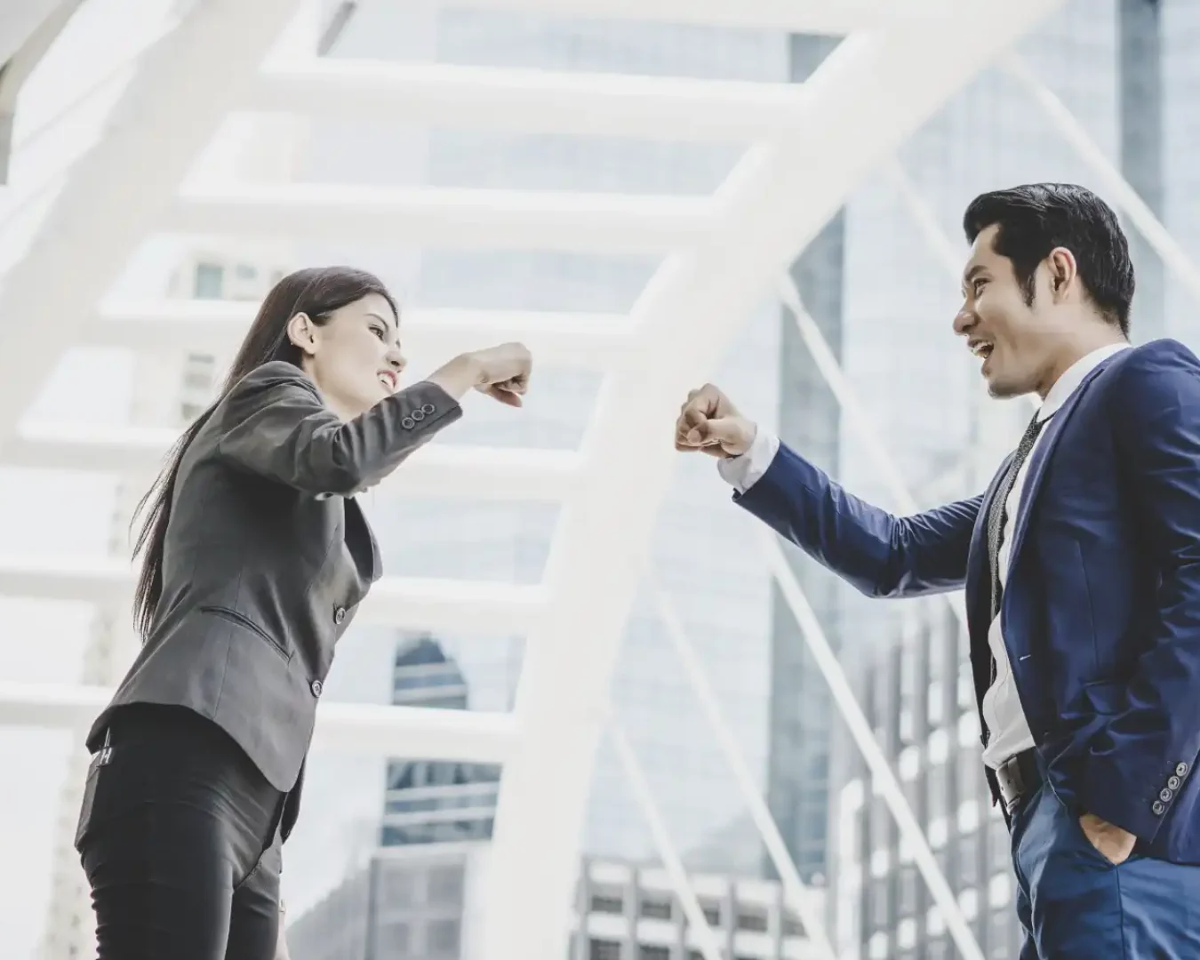 an image of a male and female business professionals doing a fist bump, symbolising the wonderful partnership we have with our clients because of our reliable business advisory and outsourcing services
