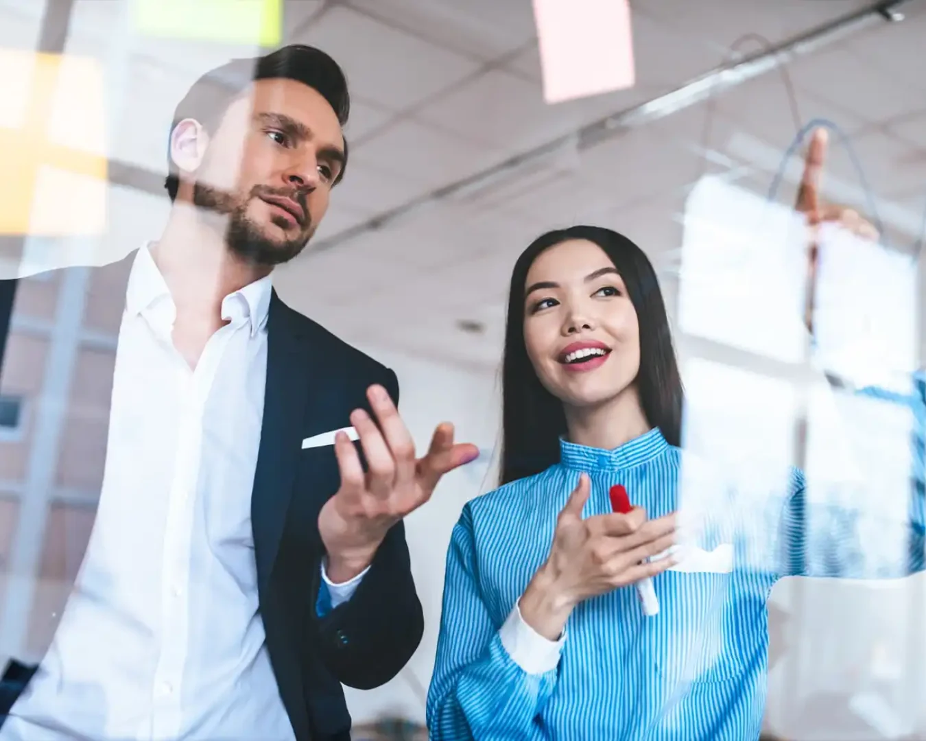 an image of a male and female financial experts discussing the potential gains of a client's investment on a board, symbolising DBA Advisory's Financial Services Advisory